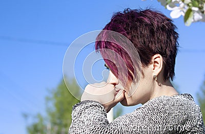 Portrait of a brooding girl with short-cropped pink hair Stock Photo