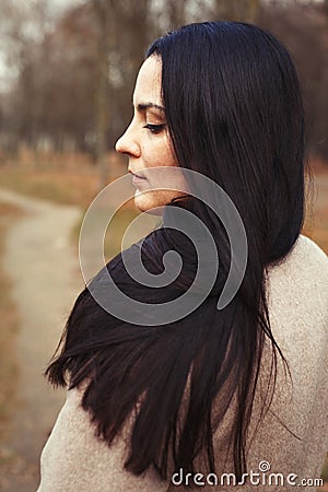 Portrait of brunette woman with thick beautiful long hair close outdoor Stock Photo