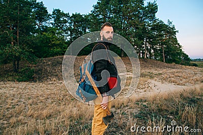 Portrait brutal bearded hipster man in the forest with ax Stock Photo