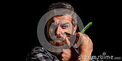 Portrait of brutal bearded man. Vintage straight razor. Mens haircut. Man in barbershop. Handsome bearded hairdresser is Stock Photo