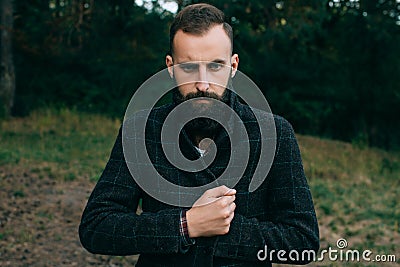 Portrait brutal bearded and moustached woodcutter hipster Gypsy man in the forest Stock Photo