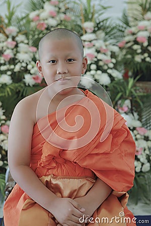 portrait of buddhist novice wearing thai monk clothes standing outdoor Stock Photo