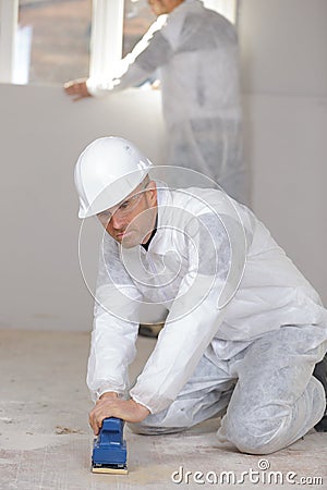 portrait builder polishing with sandpaper Stock Photo