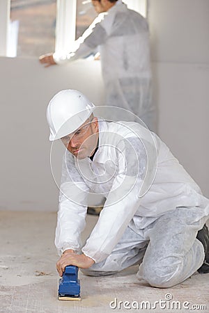 Portrait builder polishing wood floor Stock Photo