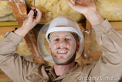 Portrait builder working on insulated ceiling Stock Photo