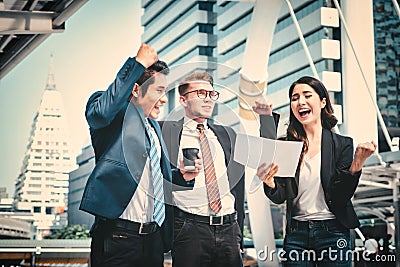 Portrait of Business team raising arms celebrate on blurred city background. Business success concept Stock Photo