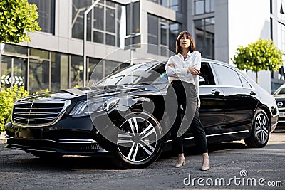 Portrait of business woman near a luxury car outdoors Stock Photo