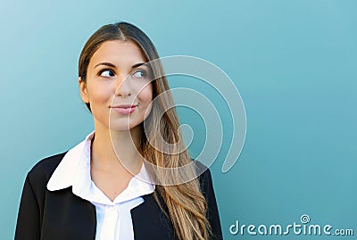 Portrait of business woman standing against blue background looking to the side. Copy space Stock Photo