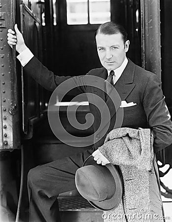 Portrait of a businessman boarding a train Stock Photo