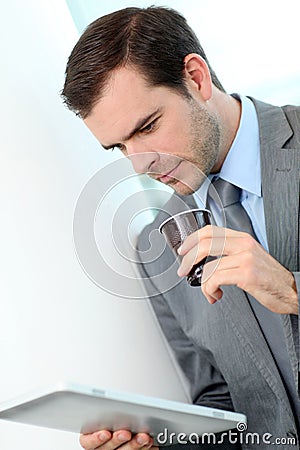 Portrait of businessman drinking take-away coffee Stock Photo