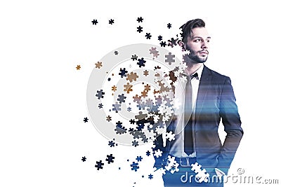 Portrait of businessman with puzzle pieces, white Stock Photo