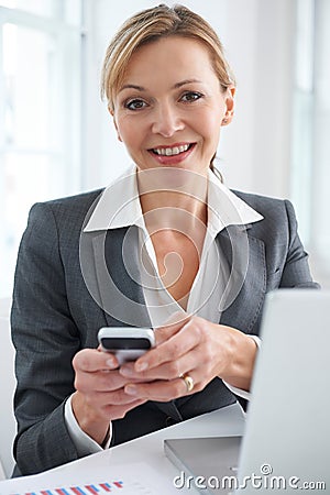 Portrait Of Businesswoman Texting On Mobile Phone Stock Photo
