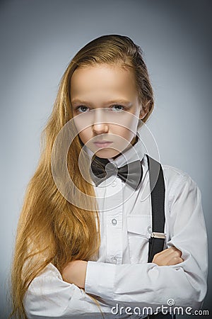 Portrait of calm and mistrust girl isolated on gray background. Normal human emotion, facial expression. Closeup Stock Photo