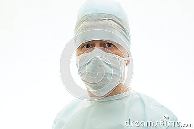 Portrait of calm surgeon in sterile gown and surgical mask Stock Photo