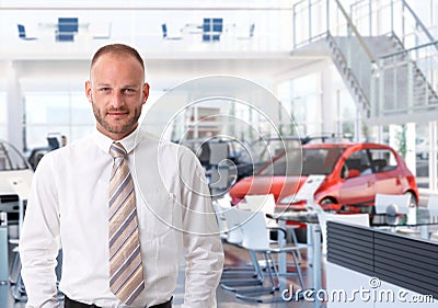 Portrait of car salesman in showroom Stock Photo