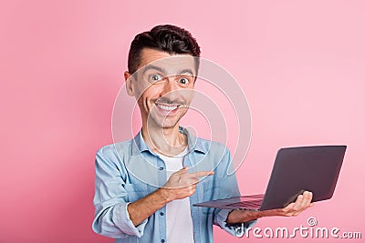Portrait caricatured face geek pointing finger computer smiling in blue shirt isolated pink color background Stock Photo