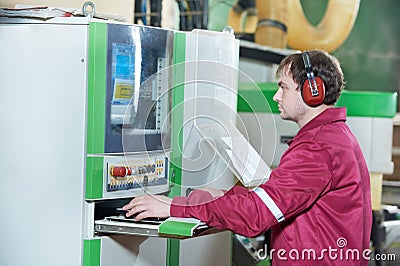 Portrait of carpentry worker with CNC machine Stock Photo