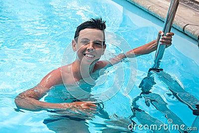 Portrait of Caucasian boy having good time in swimming pool Stock Photo