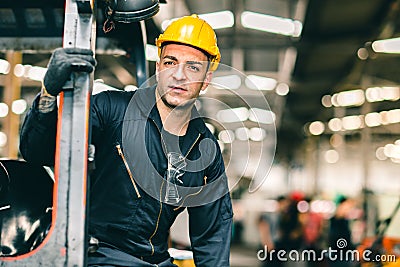 Portrait of Caucasian factory worker handsome smart with safety clothes and yellow helmet Stock Photo