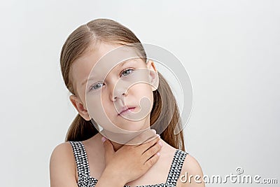 Child holding hand on throat Stock Photo