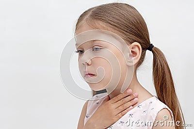 Child holding hand on throat Stock Photo