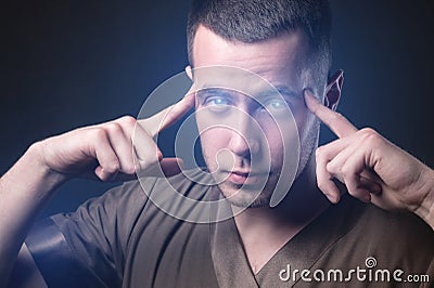 Caucasian man with glowing eyes reads your mind. Makes you suggestion and telekinesis Stock Photo