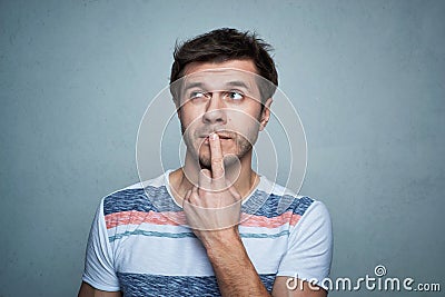 Portrait of caucasian man with think emotion on a gray background Stock Photo