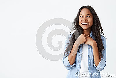 Portrait of charismatic and charming African-American woman with long wavy hair wearing stylish denim shirt, smiling Stock Photo