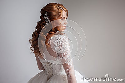 Portrait of a charming red-haired bride, Studio, close-up. Wedding hairstyle and makeup. Stock Photo