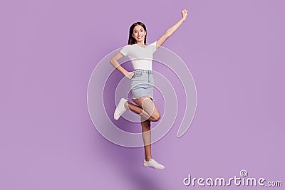 Portrait of charming sporty energetic lady jump posing hero flight on purple background Stock Photo