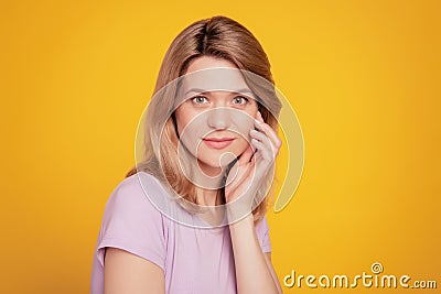 Portrait of charming tender dream lady natural sensual pose hand cheekbone on yellow background Stock Photo