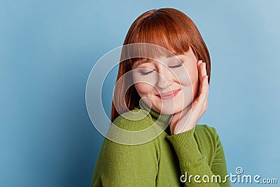 Portrait of charming tender girl with long hair isolated on blue background Stock Photo