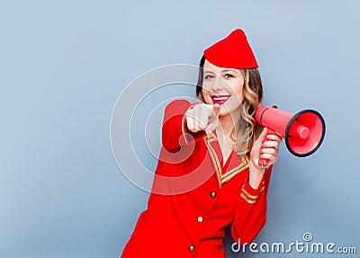 Stewardess wearing in red uniform with megaphone Stock Photo