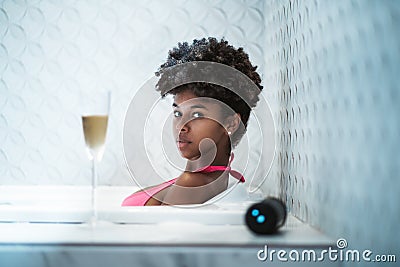 Cute young Brazilian female is laying in bath Stock Photo