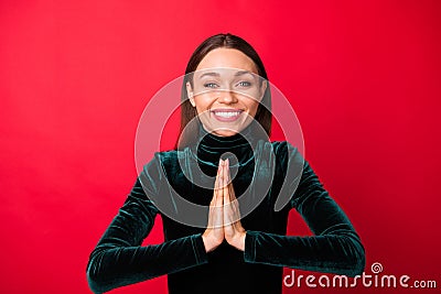 Portrait of charming youth hands together look pleading isolated over red background Stock Photo