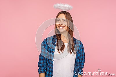 Portrait of cheerful angelic beautiful girl with nimbus over head smiling joyfully to camera Stock Photo