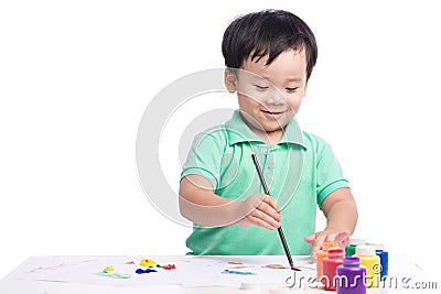 Portrait of cheerful asian boy painting using watercolors Stock Photo