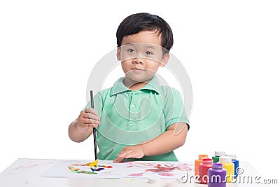 Portrait of cheerful asian boy painting using watercolors Stock Photo