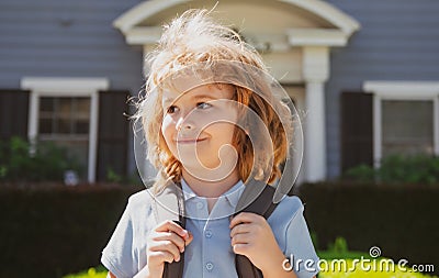 Portrait of cheerful child. Cute joyful little boy kid. Funny little child boy outdoor home, near house. Stock Photo