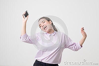 Portrait of a cheerful cute woman listening music and dancing isolated Stock Photo