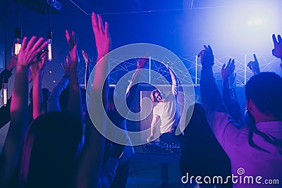 Portrait of cheerful dj party maker raise hands audience moving motion discotheque dancing floor Stock Photo