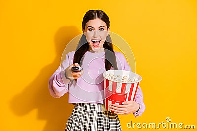 Portrait cheerful energetic girl ready watch favorite series switch remote control hold big pop corn box wear style Stock Photo