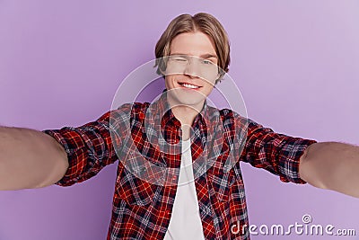 Portrait of cheerful flirty positive guy make selfie shiny smile blink eye on violet background Stock Photo