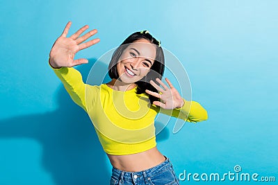 Portrait of cheerful gorgeous person toothy smile arms palms wave give high five isolated on blue color background Stock Photo