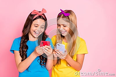 Portrait of cheerful kids laughing hold gadgets look funny information wear trendys tylish t-shirt headbands isolated Stock Photo