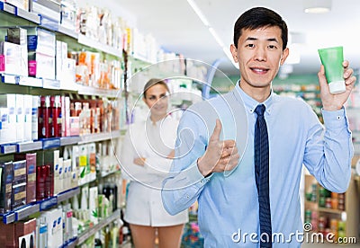 Portrait of korean man client who is satisfied of recommended medicines in pharmacy. Stock Photo