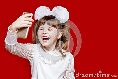 Portrait of cheerful little girl in very big glasses and white bow. Concept of eyesight or teaching Stock Photo
