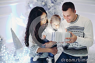 Happy family opening christmas presents with children. Stock Photo