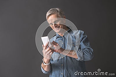 Happy retire male keeping phone Stock Photo