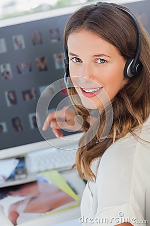 Portrait of a cheerful photo editor wearing a headset Stock Photo